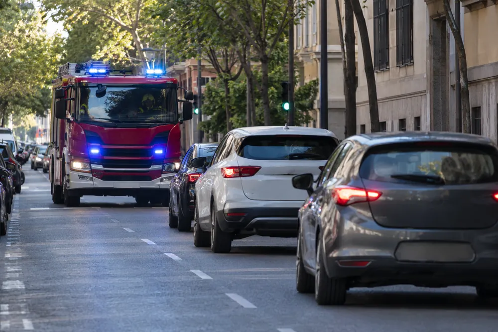 Camión de bomberos aproximándose por una calle.