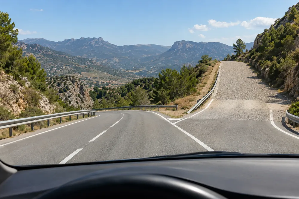Lecho de frenado de grava al lado de una carretera en una bajada larga.