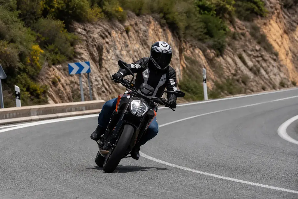 Motocicleta inclinada tomando una curva de carretera de montaña